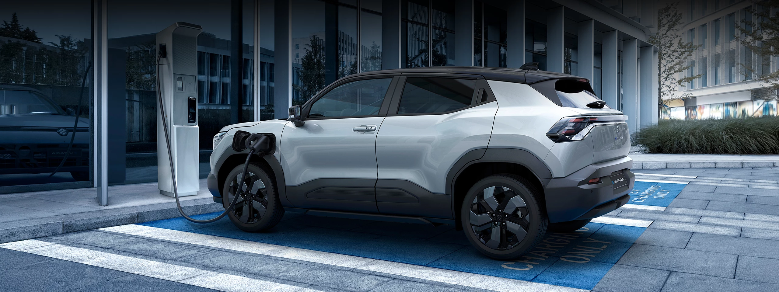 Suzuki e Vitara electric SUV plugged into an EV charging point