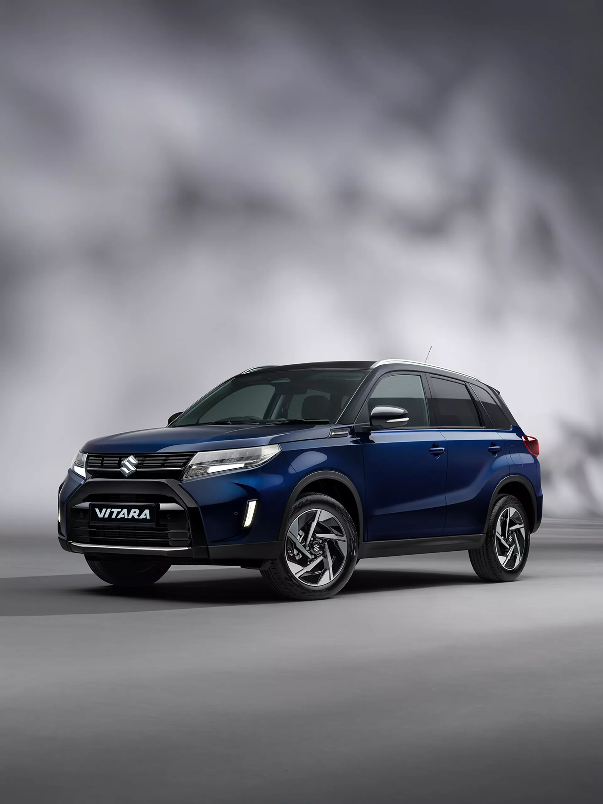Front view of the Suzuki Vitara in Sphere Blue and Cosmic Black with studio background.