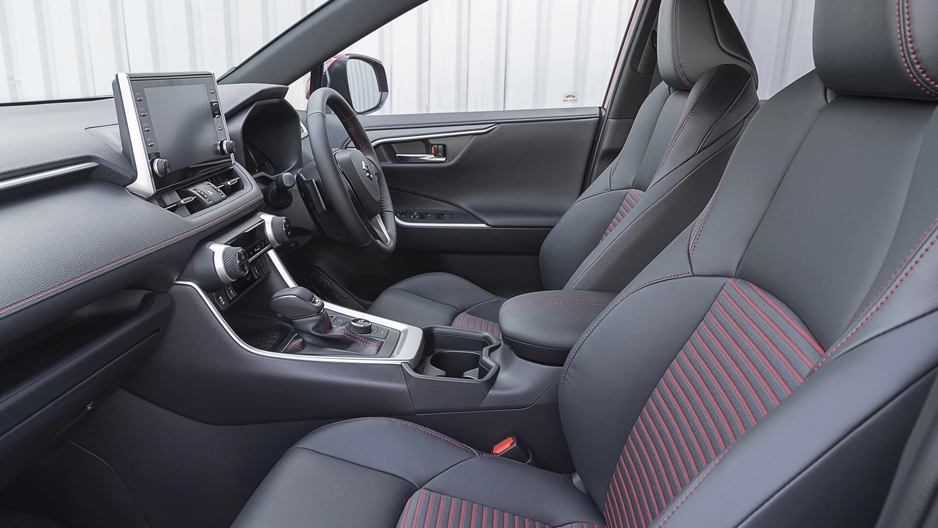 Interior view of the Suzuki Across highlighting the front adjustable driver's seat.