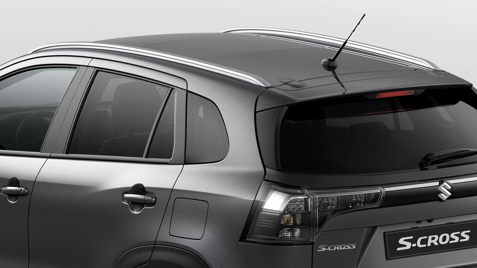 Rear-side view of Suzuki S-Cross showcasing roof rails, shark fin antenna, and LED tail lights.