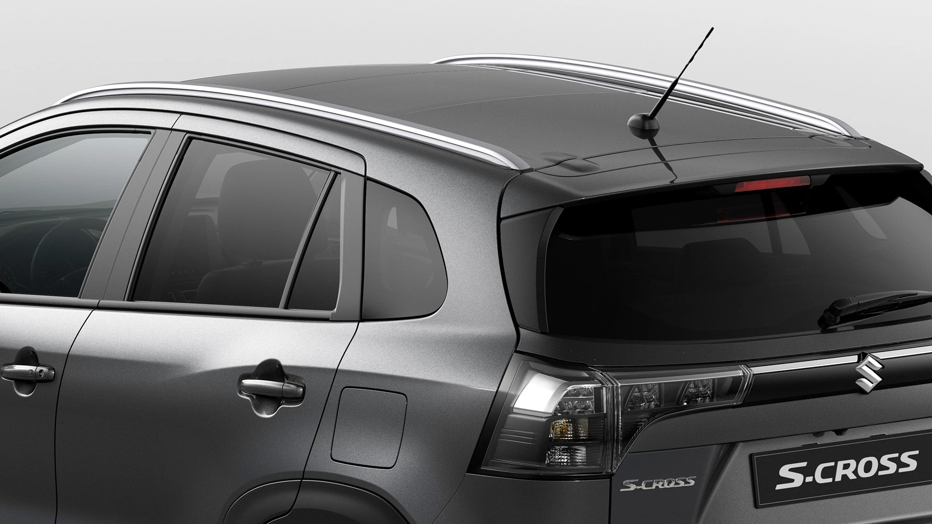 Rear-side view of Suzuki S-Cross showcasing roof rails, shark fin antenna, and LED tail lights.