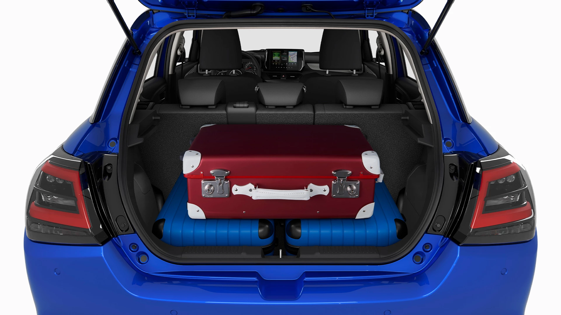 Rear view of the Suzuki Swift boot loaded with suitcases, highlighting available luggage space and split-folding rear seats