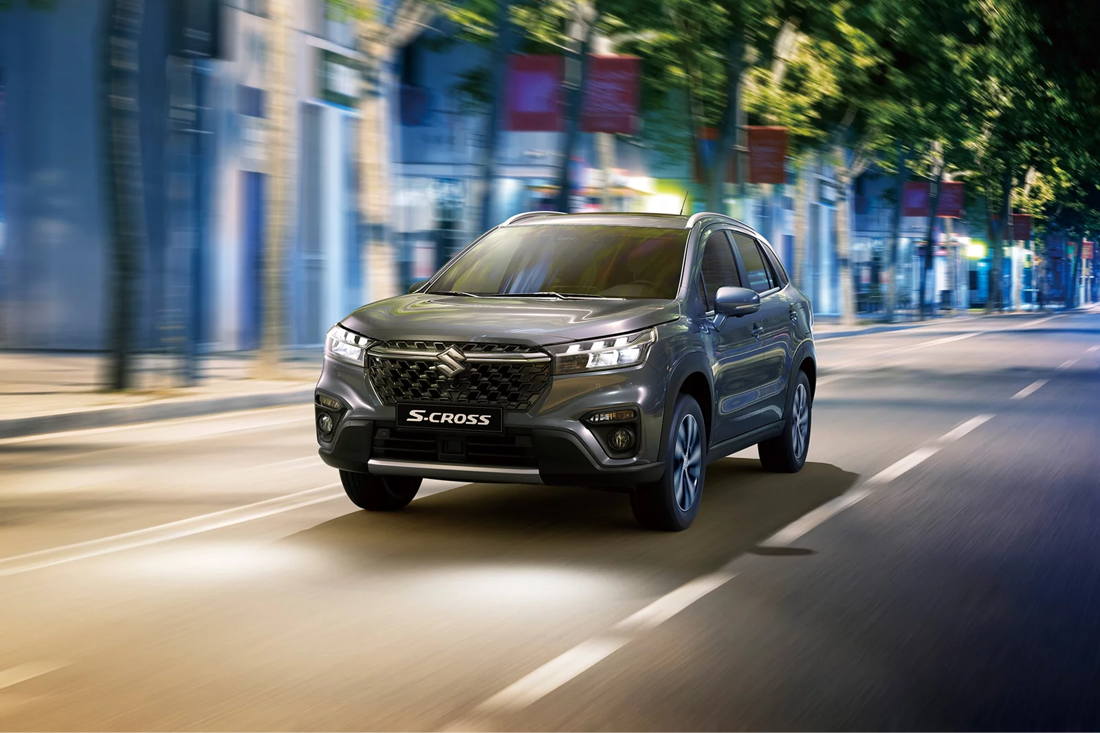 Grey Suzuki S-Cross driving through a city street at night
