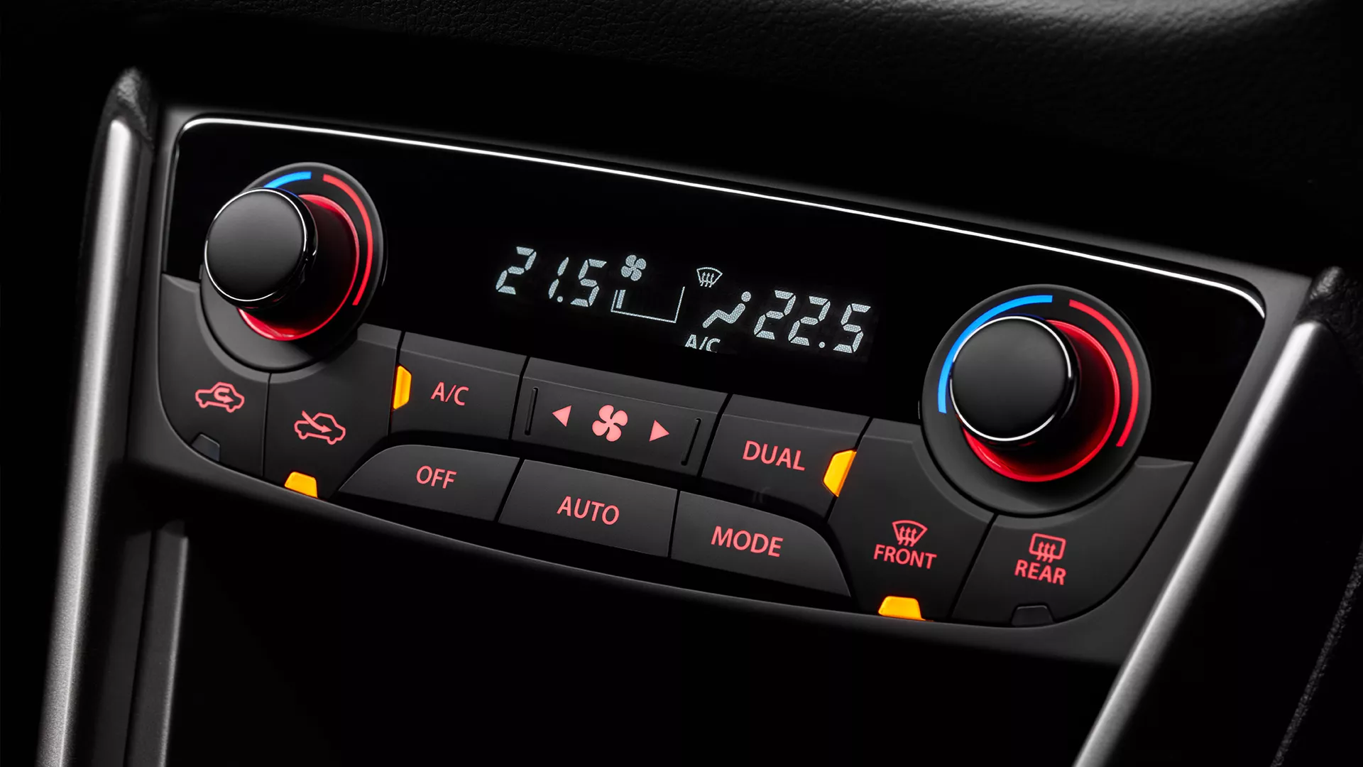 Close-up of the Suzuki S-Cross dual-zone automatic air conditioning controls, featuring separate temperature dials, digital display, and illuminated climate buttons.