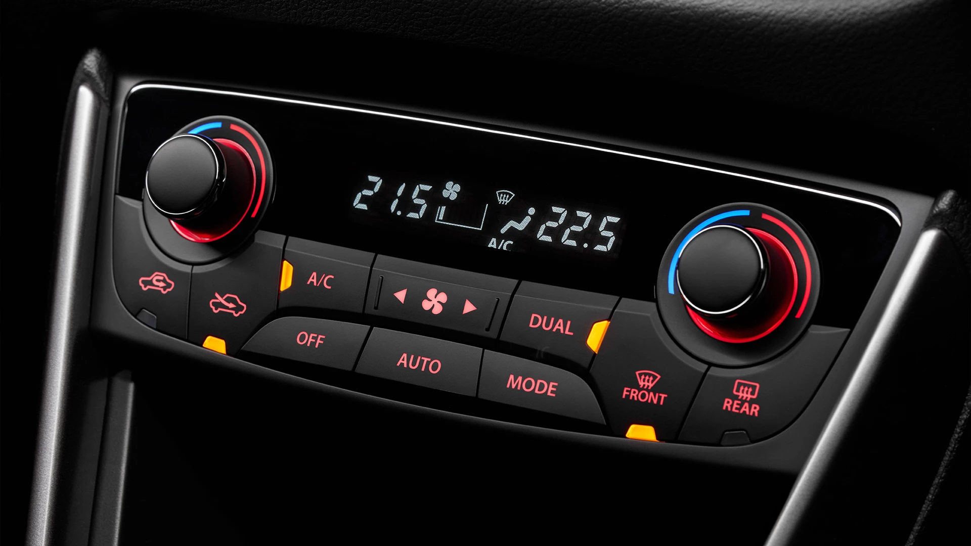 Close-up of the Suzuki S-Cross dual-zone automatic air conditioning controls, featuring separate temperature dials, digital display, and illuminated climate buttons.