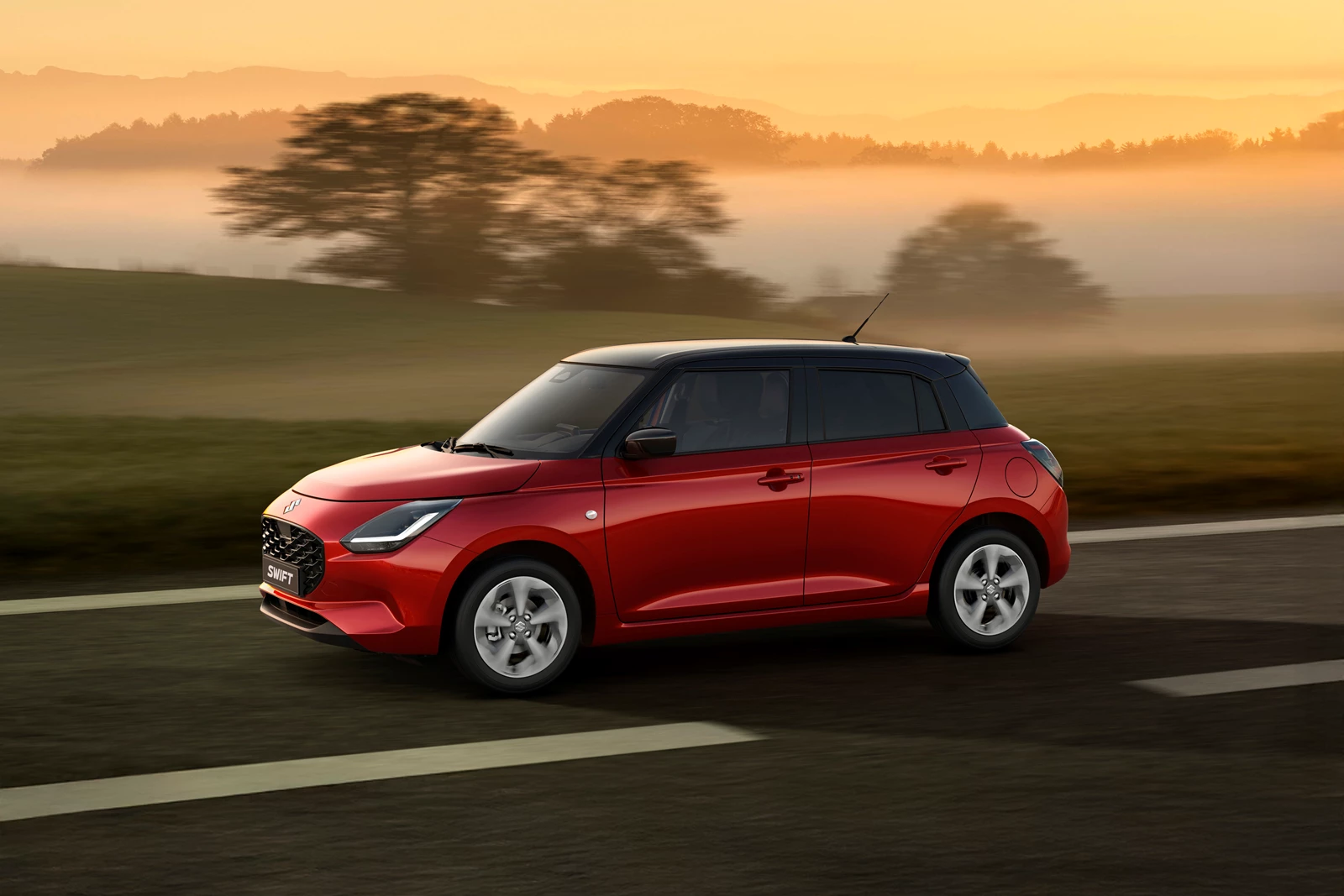Suzuki Swift red driving at sunset