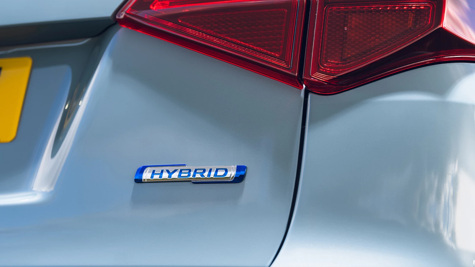 Close-up of the Suzuki Vitara’s rear tailgate showing the Hybrid badge beneath the tail light, highlighting its electrified drivetrain.