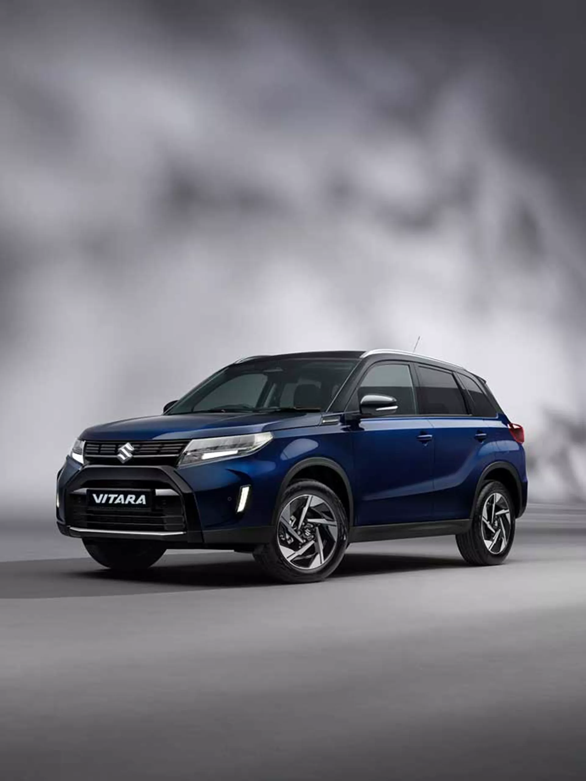 Front view of the Suzuki Vitara in Sphere Blue and Cosmic Black with studio background.