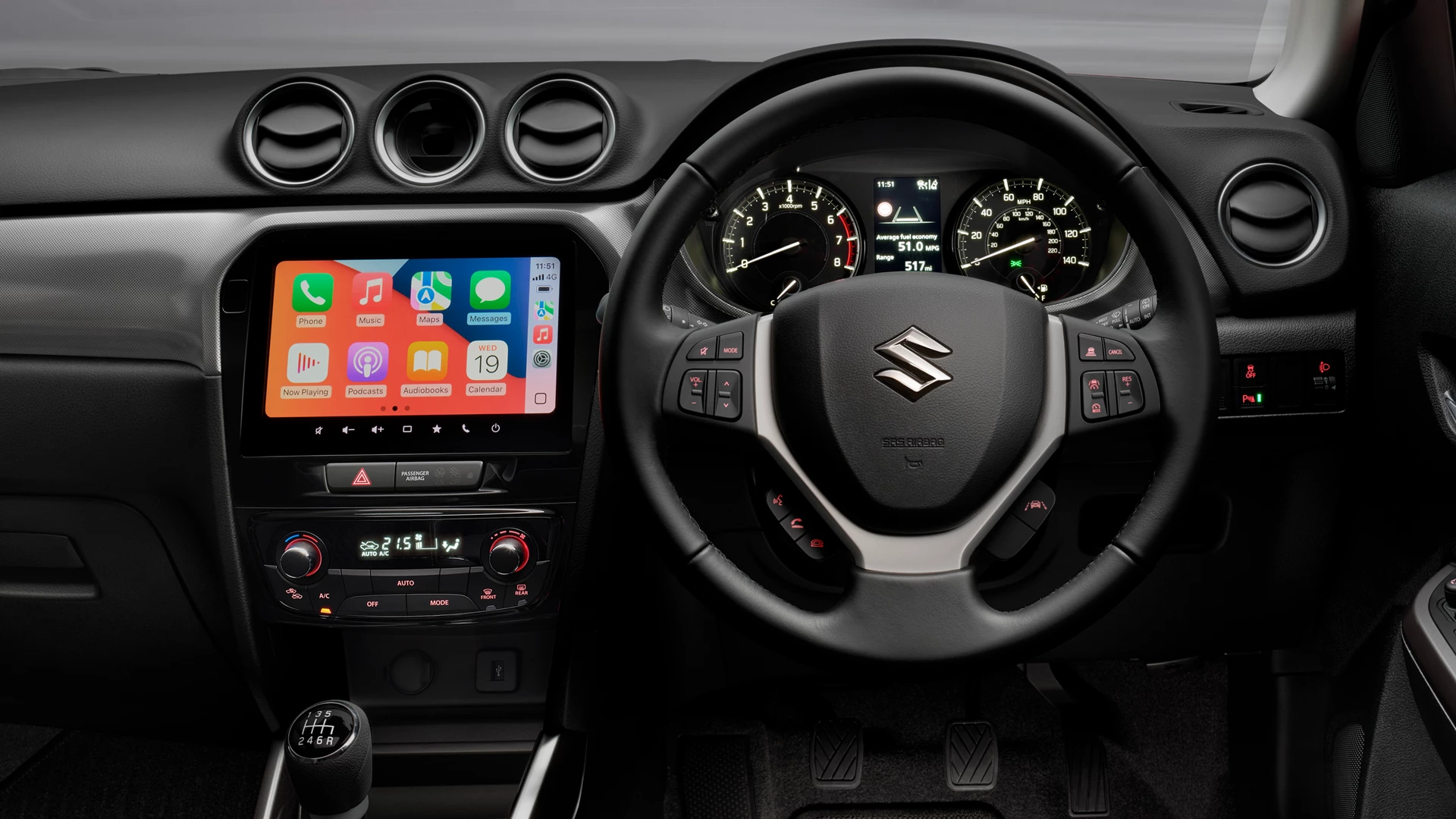 Suzuki Vitara touchscreen with Smartphone Link Display Audio showing Apple CarPlay interface.