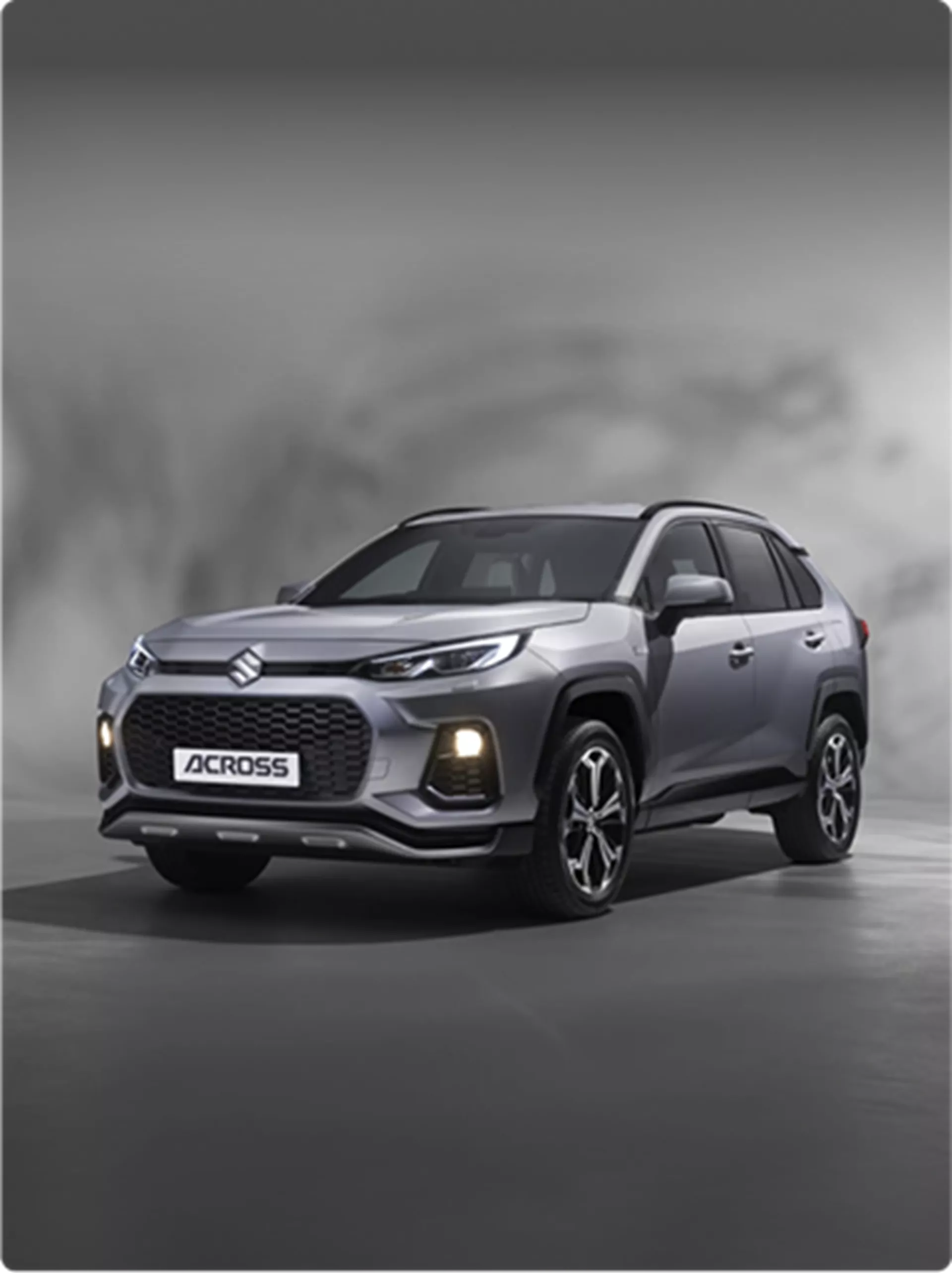 Suzuki Across plug-in hybrid SUV shown at sunset near waterfront.