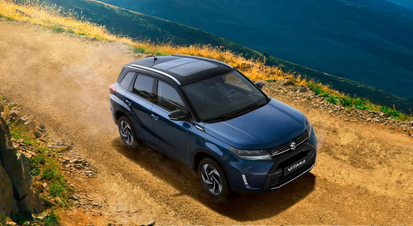 Blue Suzuki Vitara driving across a country road