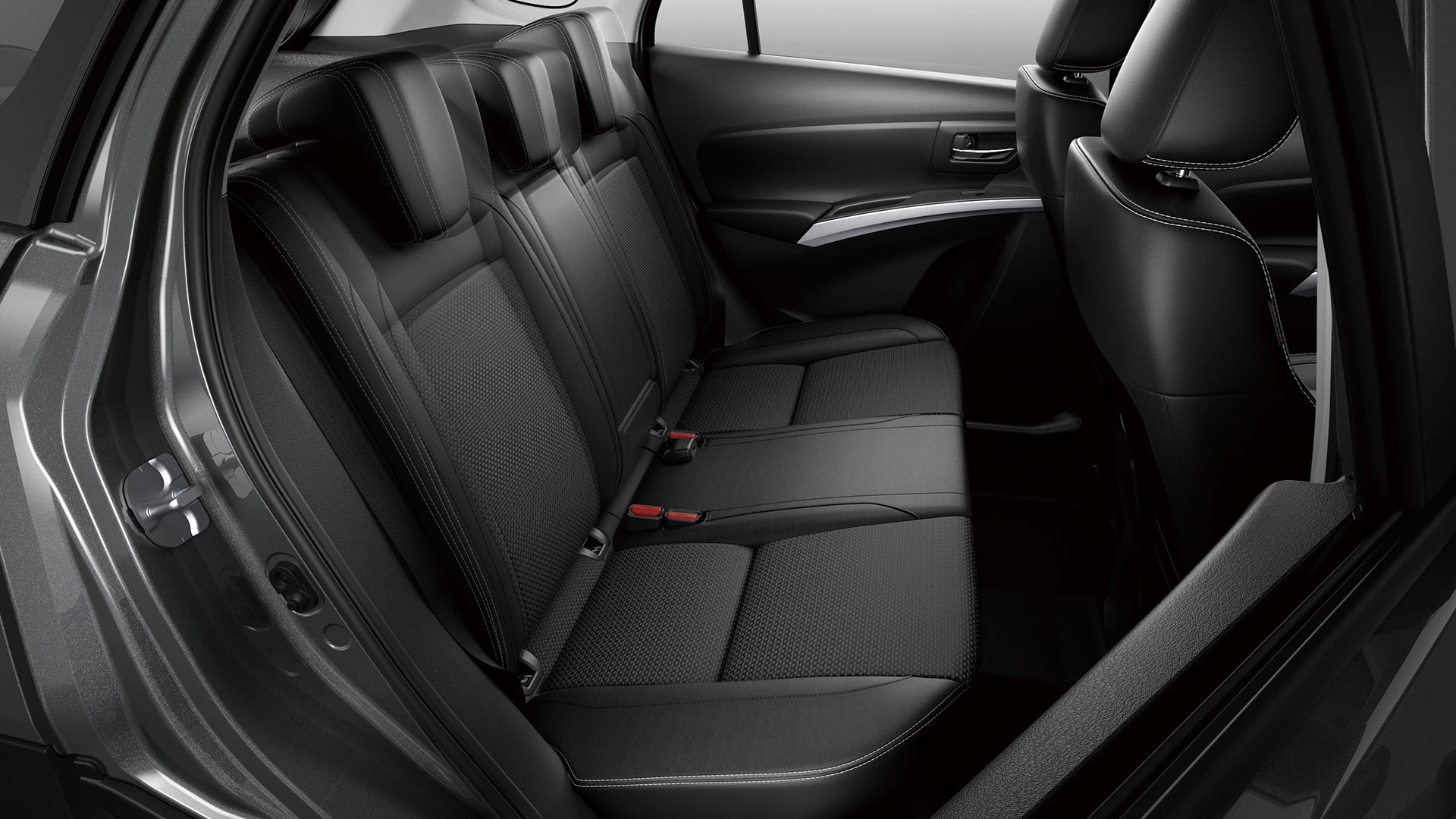 Interior view of the Suzuki S-Cross rear passenger seats, showcasing black fabric upholstery, three headrests, and spacious legroom.