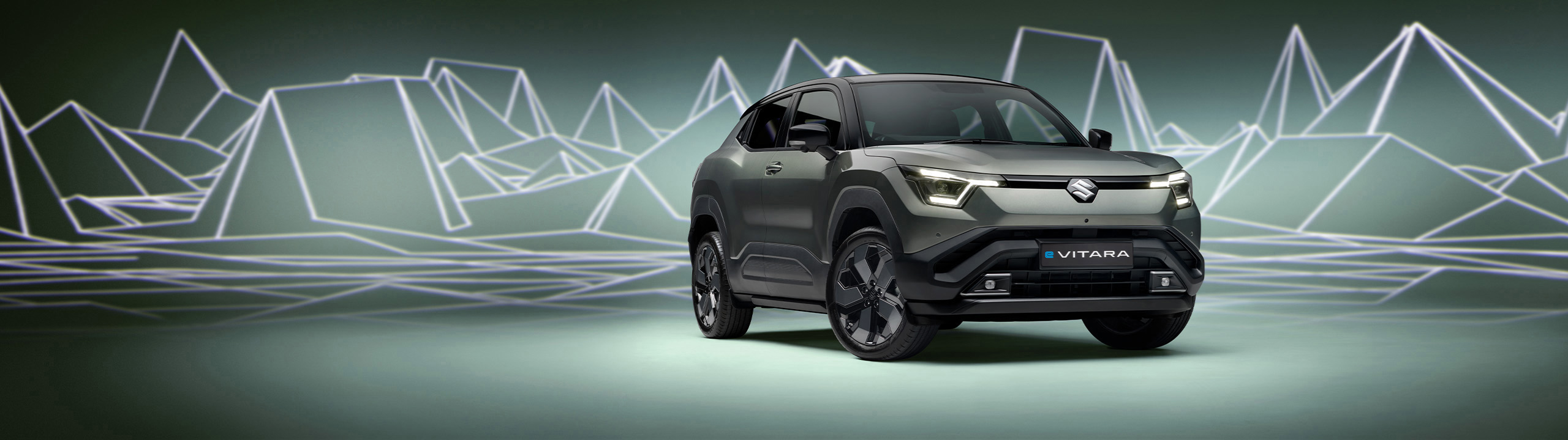 Hero banner of the Suzuki e Vitara highlighting its sculpted front design, LED lighting and alloy wheels