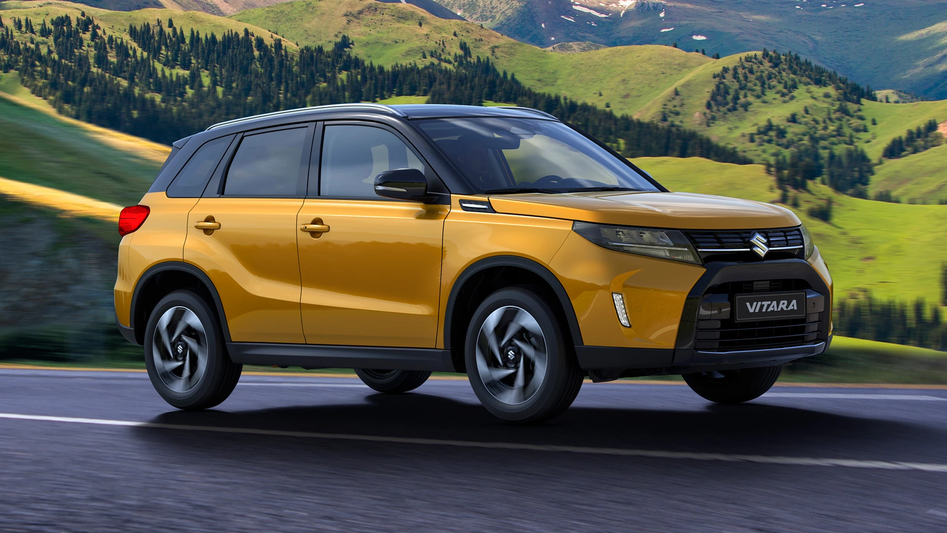 Suzuki Vitara in solar yellow driving along a scenic mountain road, showcasing its bold front-side profile and rugged SUV styling.