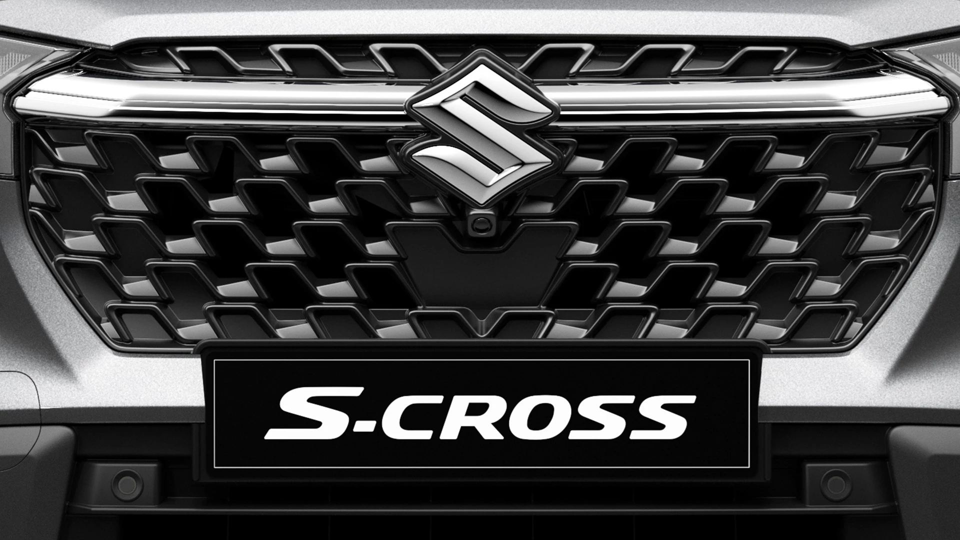 Close-up of Suzuki S-Cross front grille with bold honeycomb design and central Suzuki emblem.