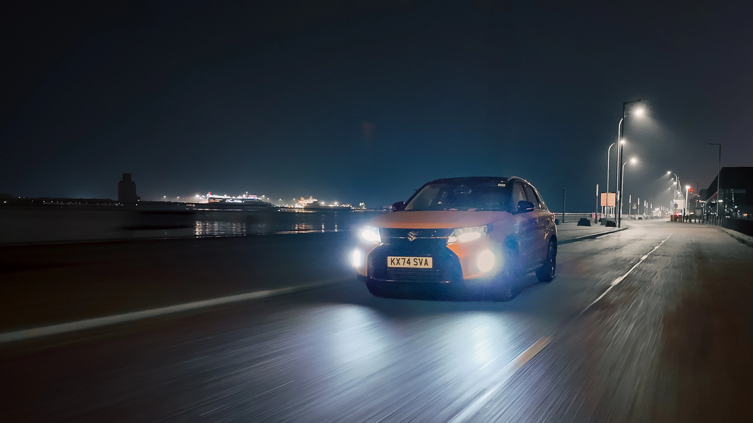 Front view of a Suzuki Vitara driving at night in the city
