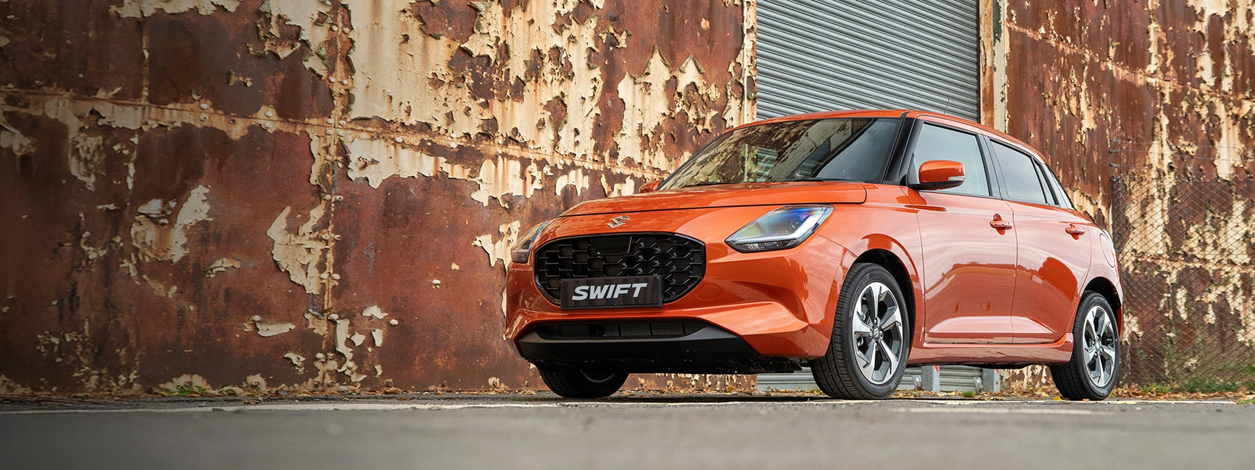 The orange Suzuki Swift model