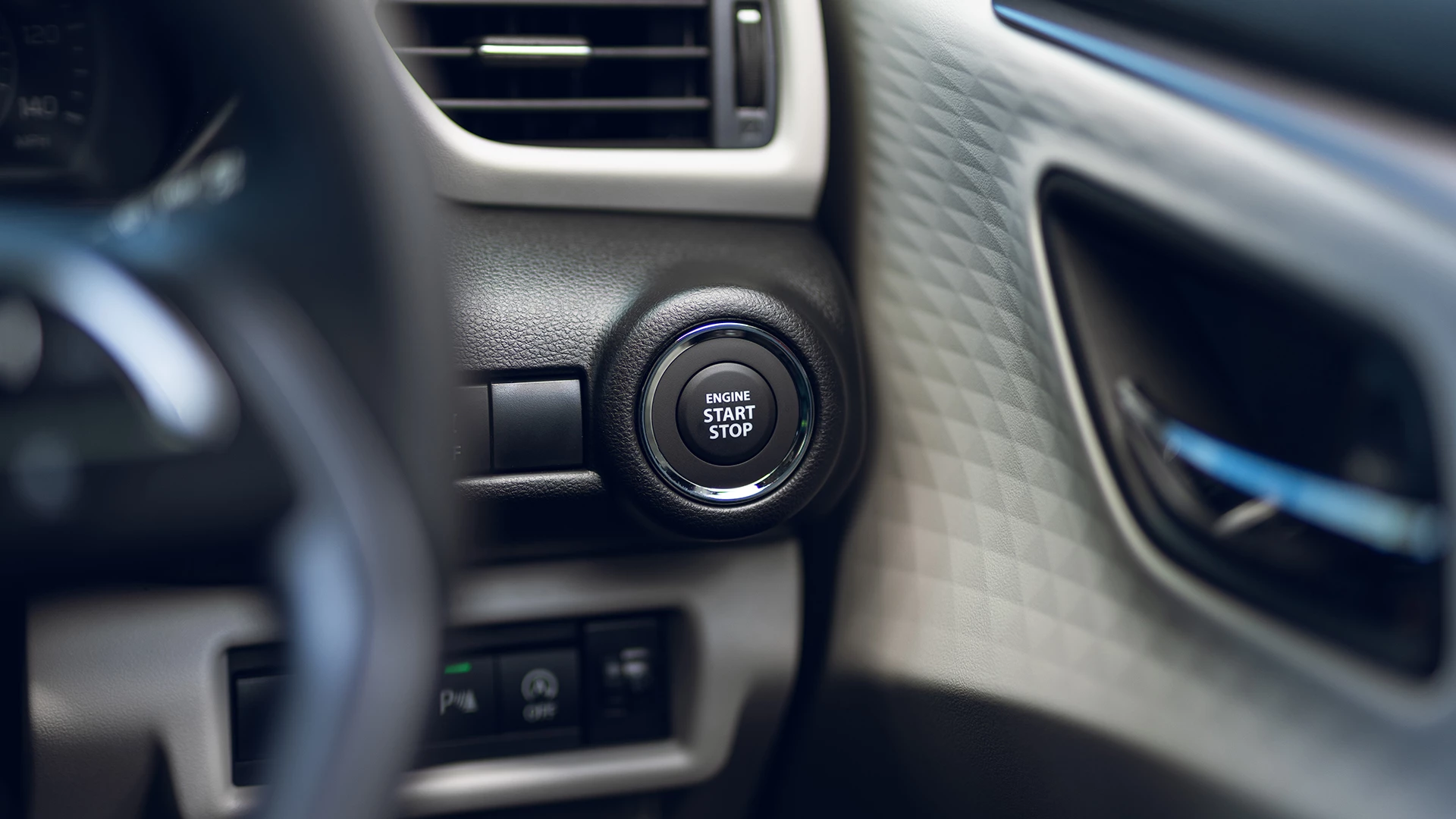 Close-up of the Suzuki Swift interior showing the Engine Start Stop button for keyless entry and push-button start functionality