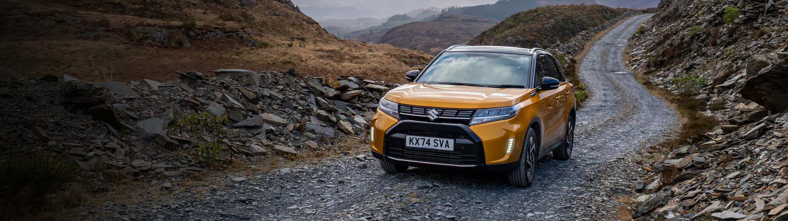 Suzuki car driving on a mountain road