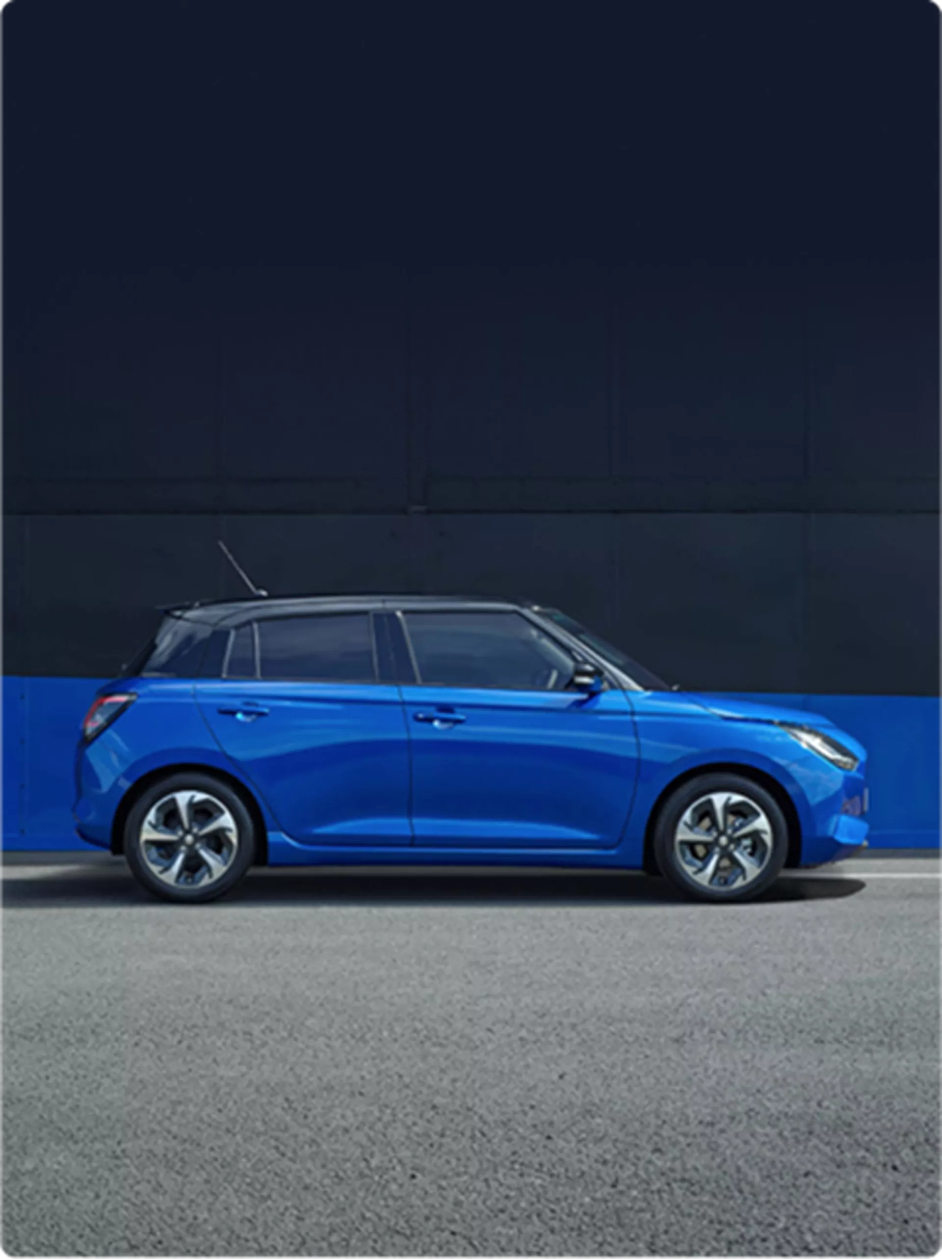 Side view of the Suzuki Swift Hybrid parked in frontier blue and super black.