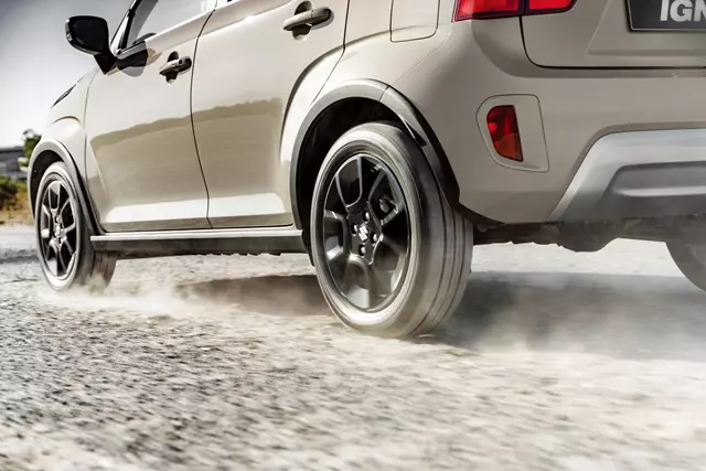 Suzuki Ignis driving on a dirt road