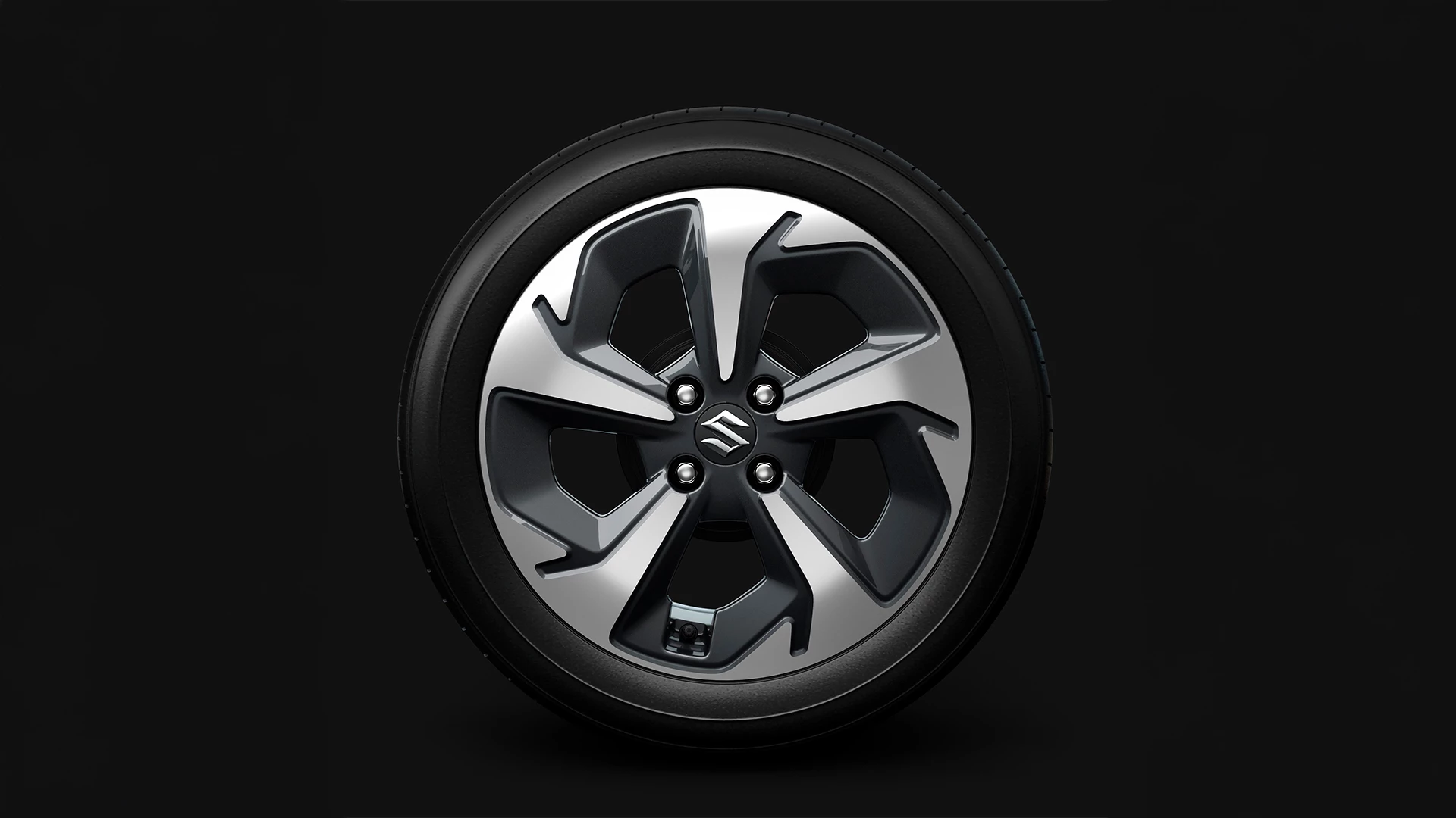 Suzuki Swift 16-inch alloy wheel with dual-tone finish and Suzuki logo at the centre