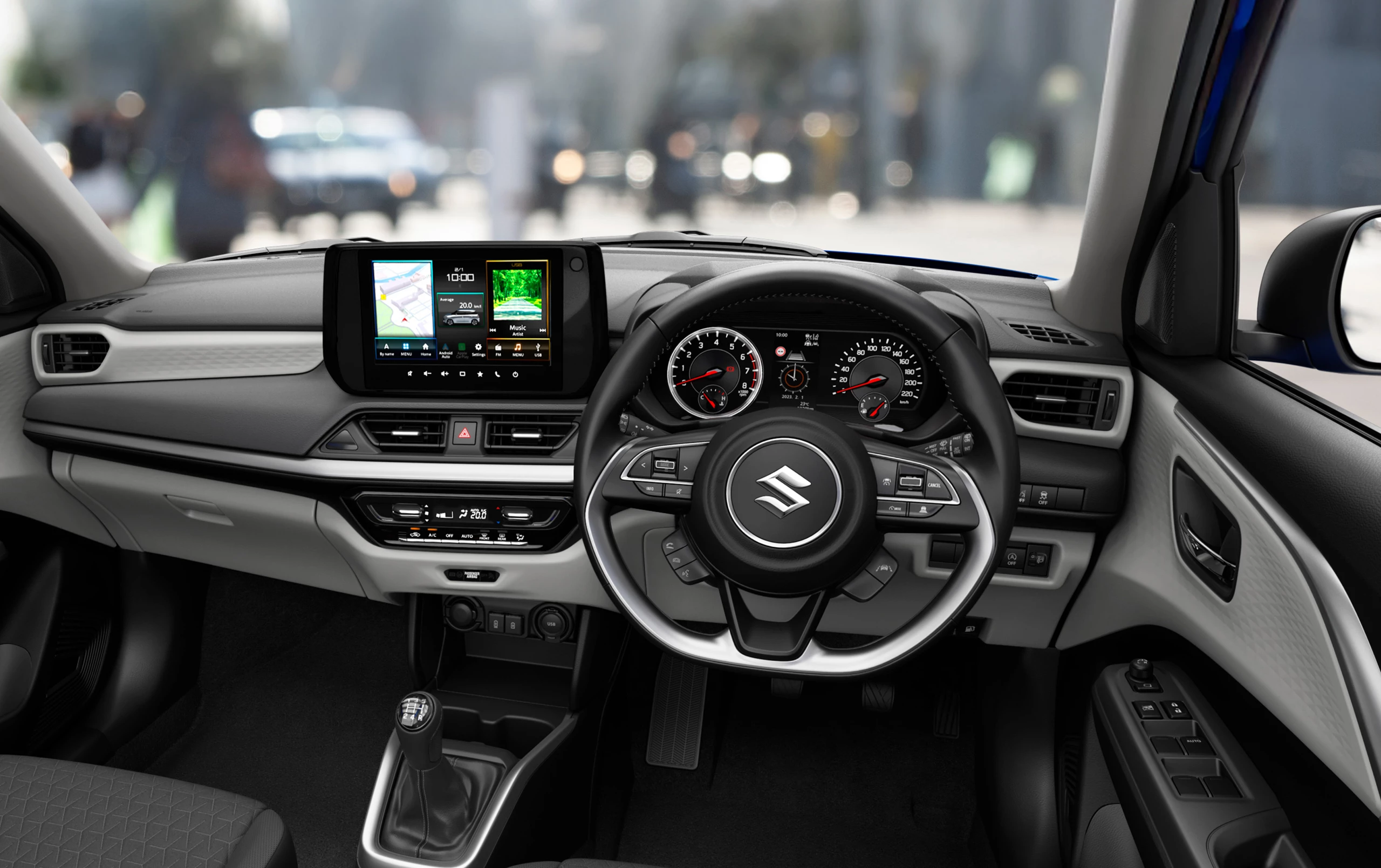 Interior view of the Suzuki Swift showcasing the 9-inch multimedia display, steering wheel controls, and modern dashboard layout