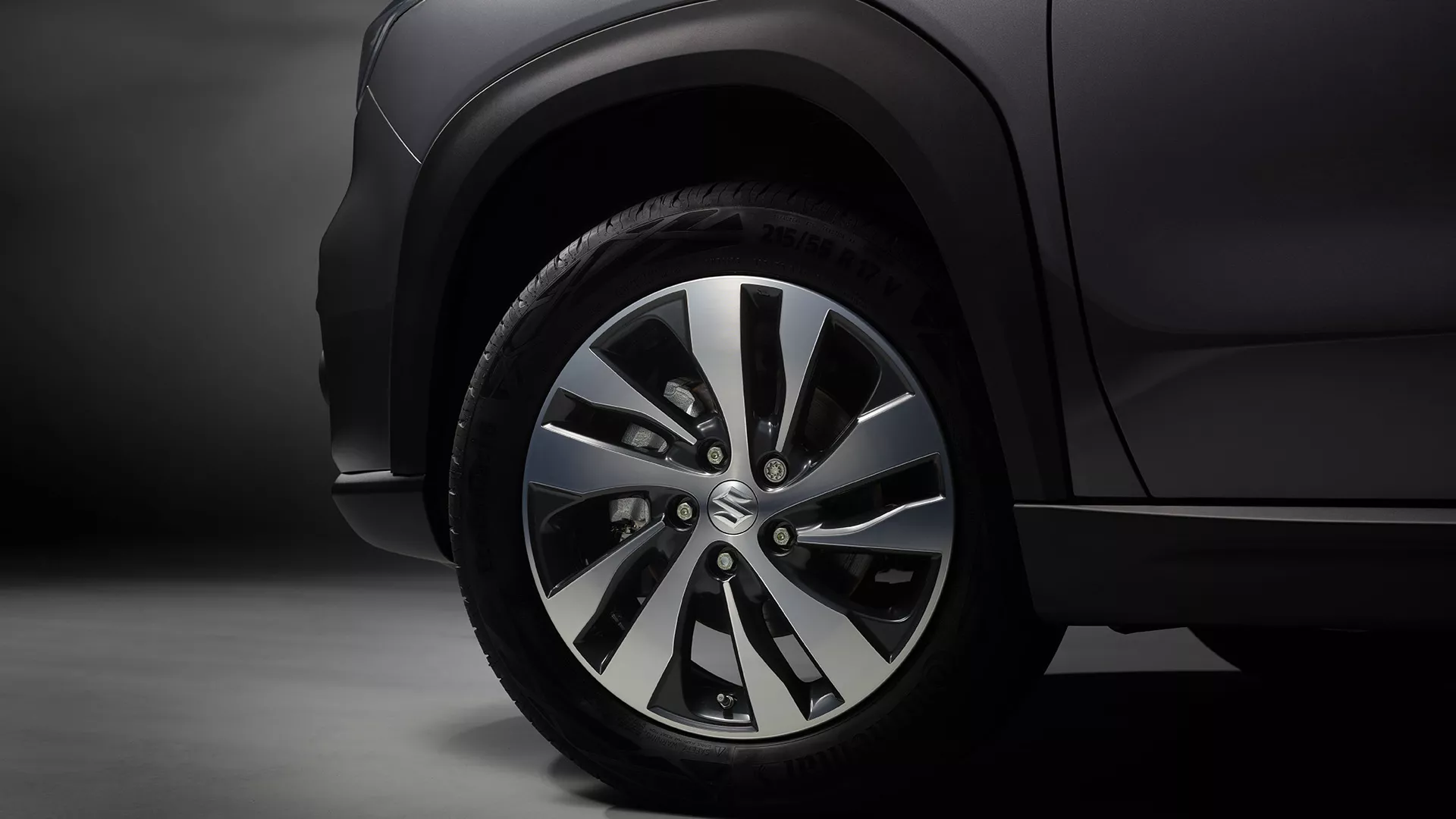Close-up of Suzuki S-Cross alloy wheel and front wheel arch with two-tone finish.