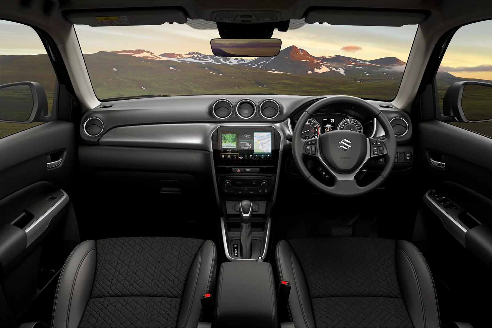Interior dashboard and front cabin of a Suzuki vehicle with mountain scenery through the windscreen