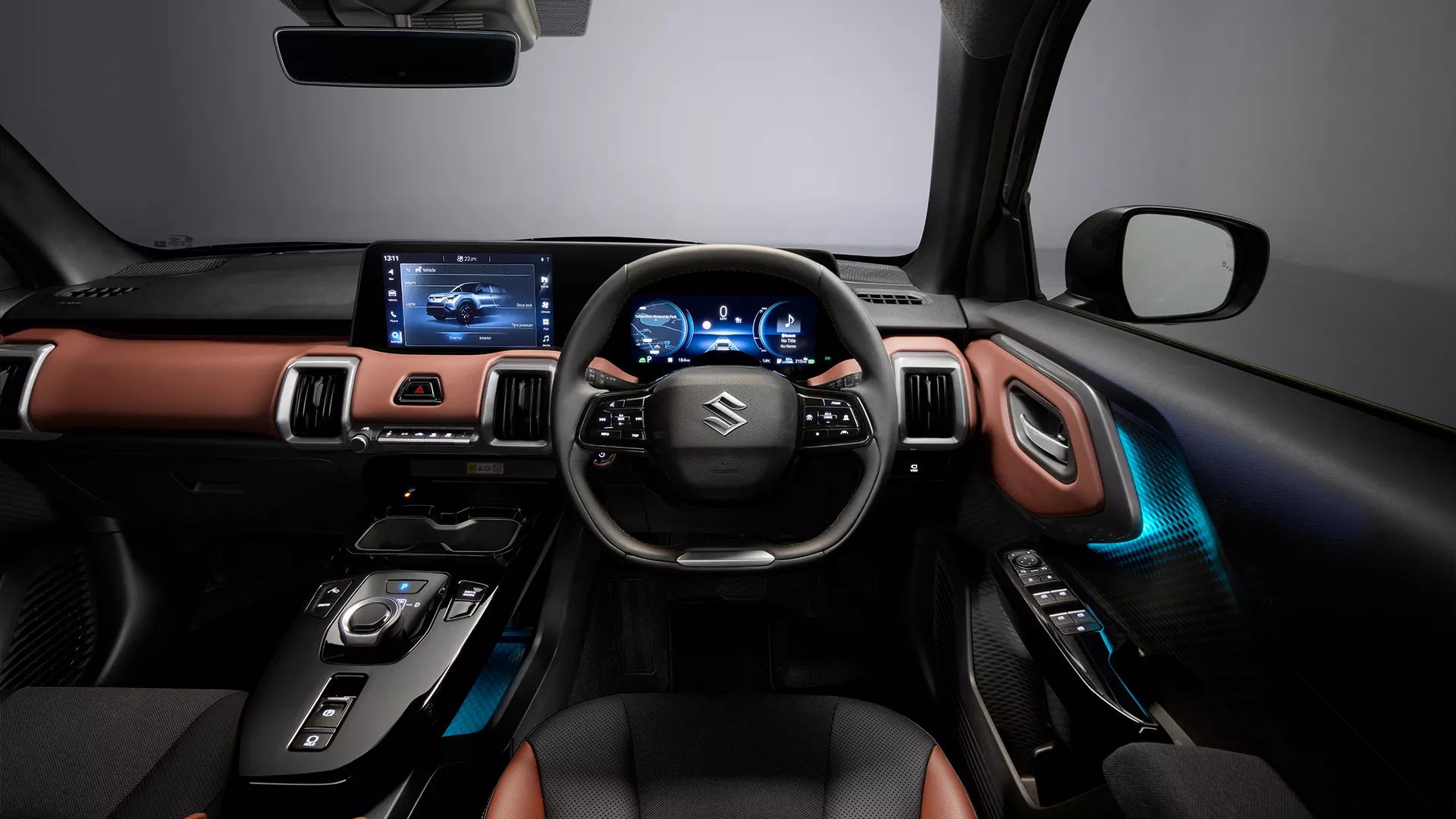 Interior dashboard view of the Suzuki e Vitara featuring digital displays, ambient lighting, and premium two-tone trim.