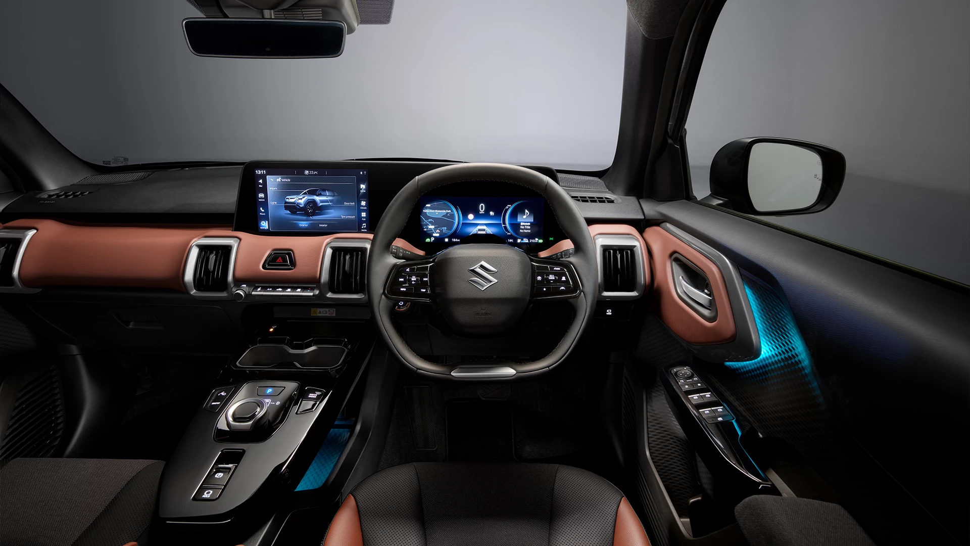 Interior dashboard view of the Suzuki e Vitara featuring digital displays, ambient lighting, and premium two-tone trim.