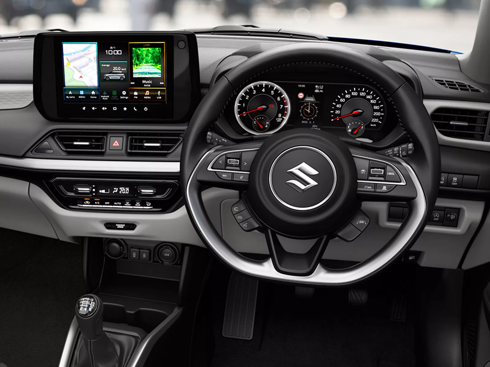 Interior view of the Suzuki Swift showcasing the 9-inch multimedia display, steering wheel controls, and modern dashboard layout