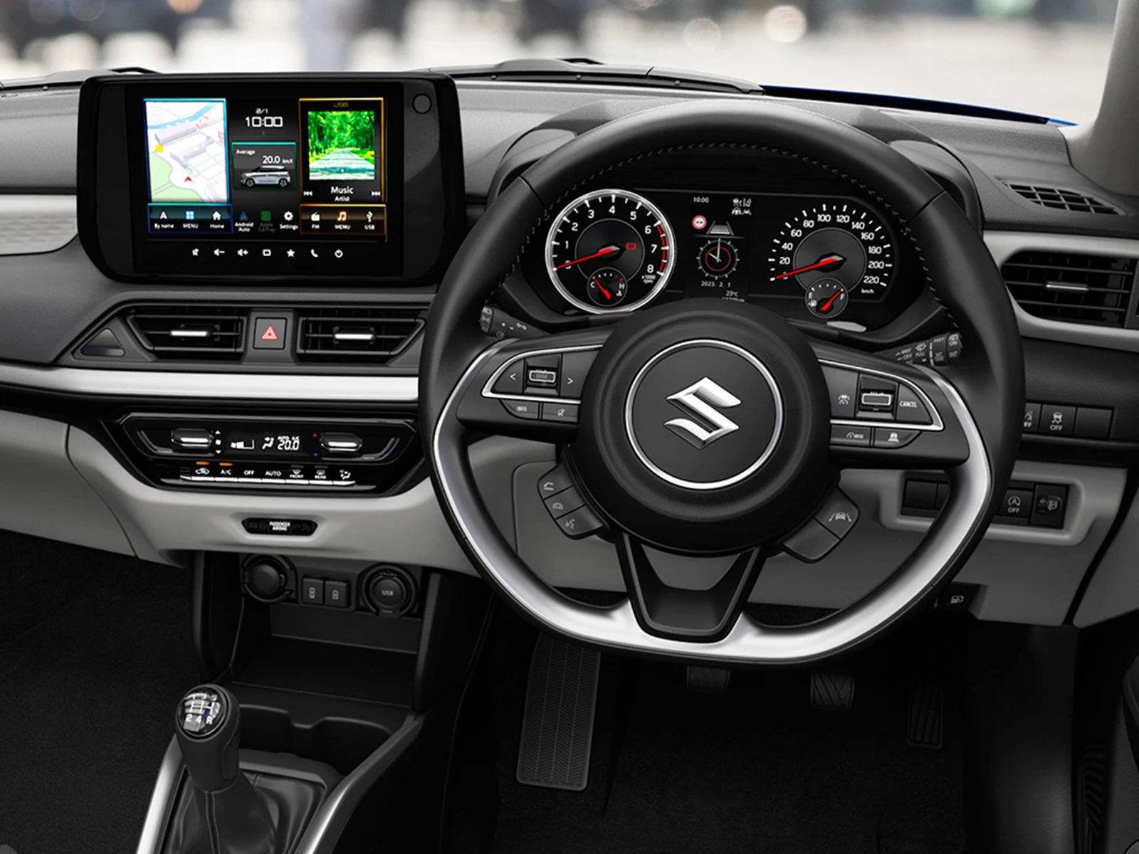 Interior view of the Suzuki Swift showcasing the 9-inch multimedia display, steering wheel controls, and modern dashboard layout