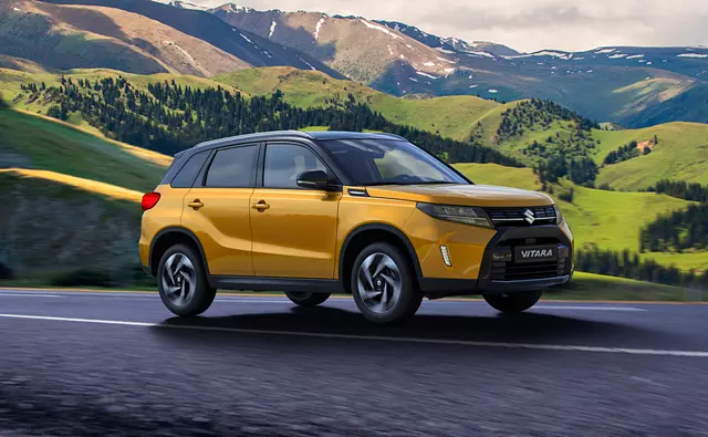 Suzuki Vitara yellow driving through mountains