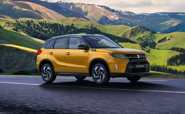 Suzuki Vitara yellow driving through mountains