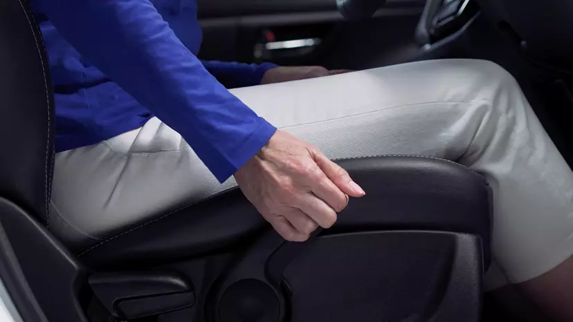 Adjusting the seat and steering wheel position in a Suzuki car.