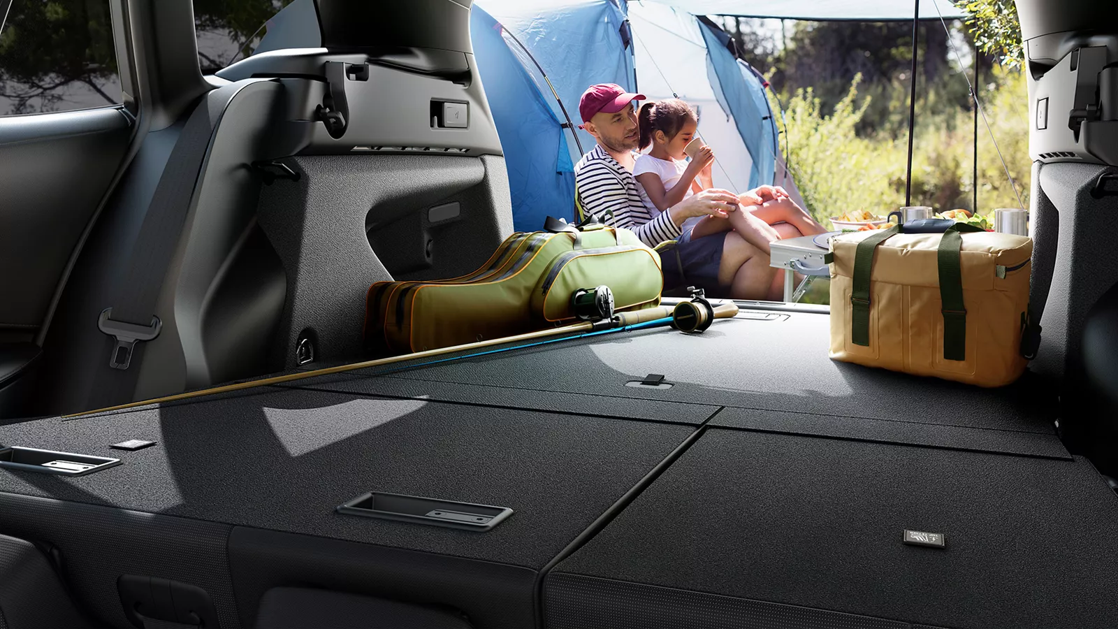 View from Suzuki Swace boot showcasing flat load space with camping gear, highlighting luggage capacity and lifestyle versatility with family camping scene outside.