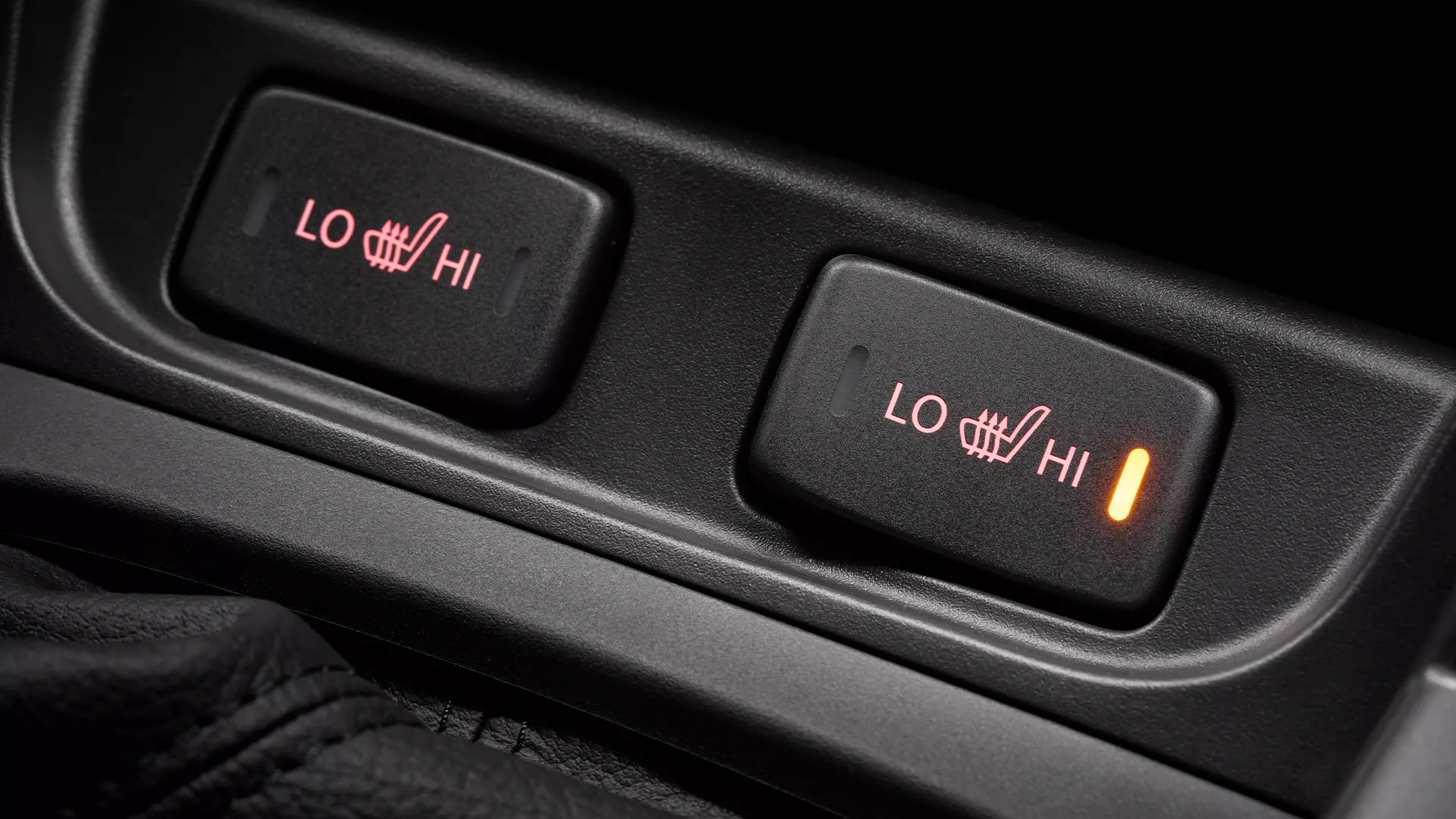 Close-up of Suzuki S-Cross heated seat controls showing illuminated high setting, with LO and HI adjustment options for enhanced comfort.