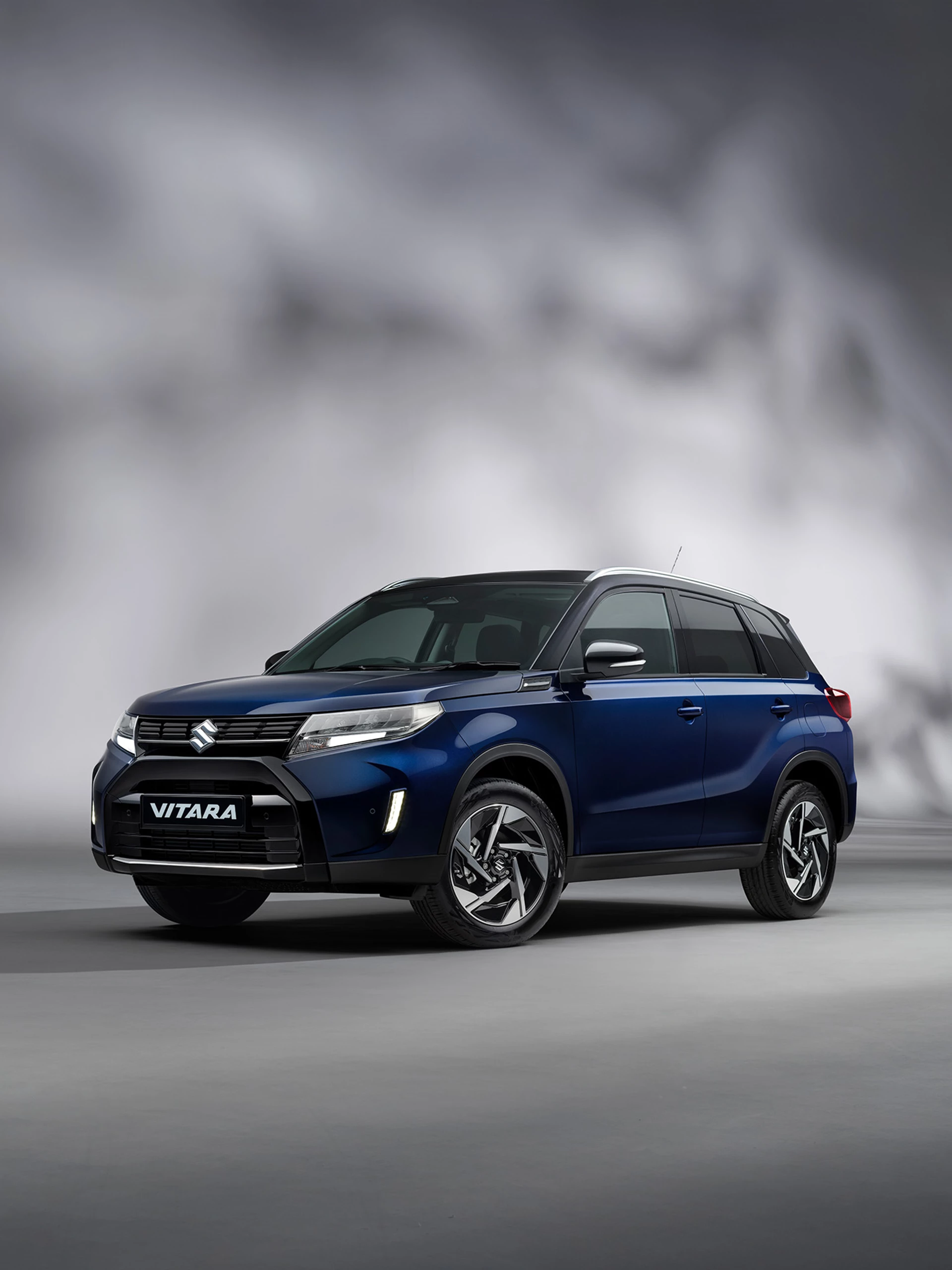 Suzuki Vitara hybrid SUV with city background.